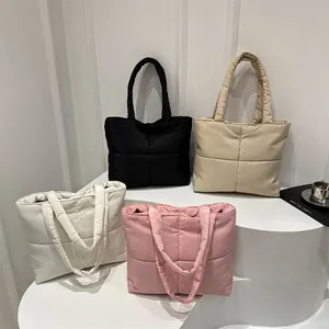 Quilted nylon down tote bags in black, beige, white, and pink with large square stitching