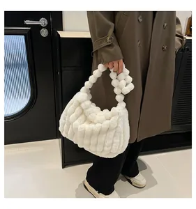Detailed view of the white plush tote bag with a unique round fluffy ball handle design