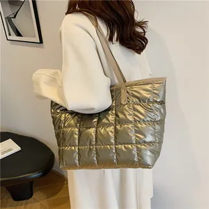 Champagne gold quilted puffer tote bag with large capacity shown in a lifestyle shoulder view