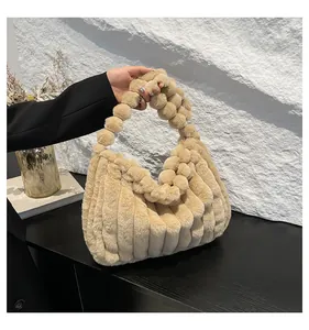 Detail of beige plush handbag with soft faux fur texture and bubble handle design