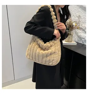 Detail of plush shoulder bag featuring unique spherical strap and vertical stripe texture