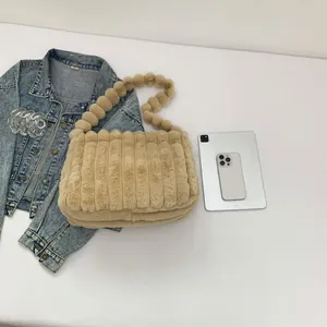 Fuzzy khaki tote bag with plush striped texture and unique beaded shoulder strap
