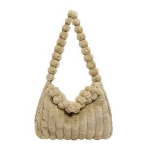 Fuzzy khaki tote bag with plush textured stripes and a unique pom-pom beaded shoulder strap