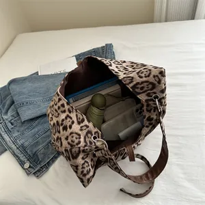 Large leopard print tote bag with brown leather handles and spacious interior storage