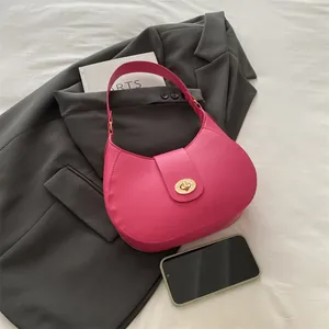 Chic magenta PU leather crescent shoulder bag with golden lock and wide strap
