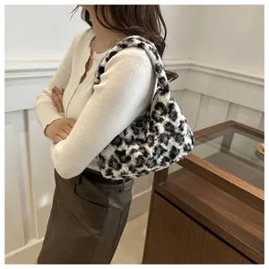 Side view of a fuzzy leopard print plush shoulder bag on a model with soft faux fur texture