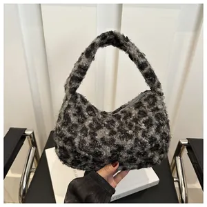Close-up of fluffy grey leopard faux fur texture on a crescent tote bag with handle