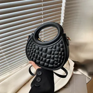 Chic black semi-circular handbag with textured grid pattern and gold hardware