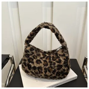 Detailed view of the leopard print faux fur texture and silver metal zipper on the tote bag