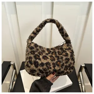 Close-up of leopard print plush tote bag with silver zipper and soft fuzzy texture