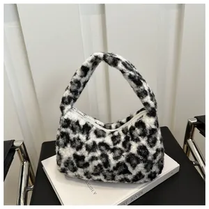 Close-up of the soft leopard print faux fur texture and smooth white zipper closure