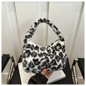 Close-up of plush faux fur texture and leopard pattern on a stylish winter tote bag