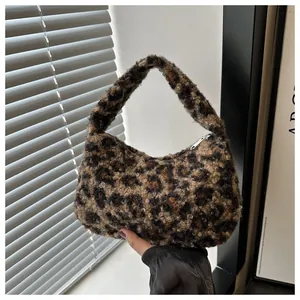 Close-up of leopard print faux fur tote bag with a metallic silver zipper detail