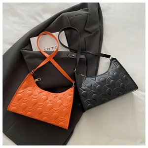 Detail of hobo shoulder bag featuring fan-shaped quilting and golden metal zipper