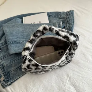 Chic black and white leopard print plush tote bag with zipper closure and soft faux fur texture