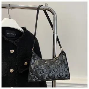 Close-up of black PU leather underarm bag featuring unique semi-circular embossed texture