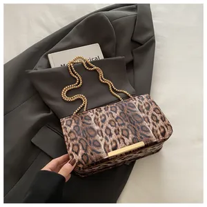 Close-up of leopard print shoulder bag featuring a golden chain and textured faux fur