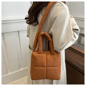 Brown quilted puffer tote bag with wide shoulder strap and soft padded material