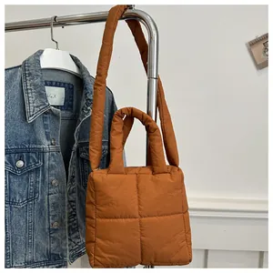 Close-up of caramel quilted puffer tote bag with soft square padding on metal hanger