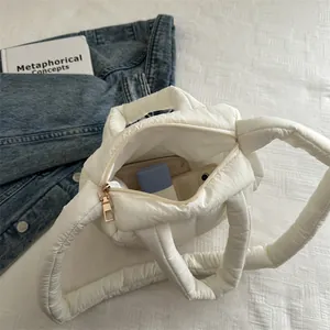 Quilted cream puffer tote bag with zipper closure and spacious interior for daily use