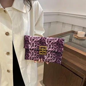 Fashionable purple leopard print clutch bag with golden metal buckle and faux fur texture