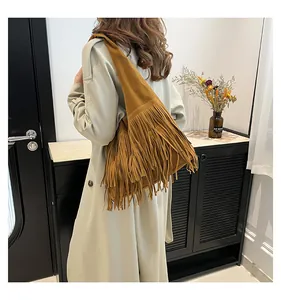 Detail of vintage brown suede tote bag with long fringes and wide shoulder strap