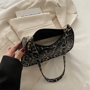 Minimalist leopard print hobo shoulder bag with a sleek metallic zipper closure