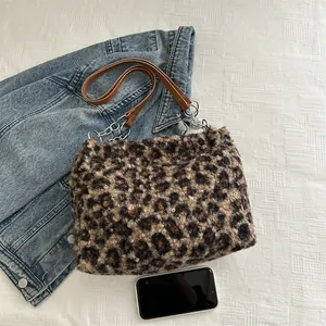 Retro leopard print plush tote bag with leather strap and chain shown on denim jacket