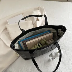 Large black vintage tote bag with wavy texture and interior space for tablets and daily items