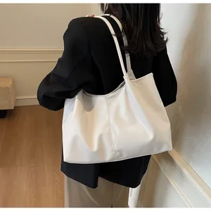 Detailed back view of a white ruched oversized tote bag made of glossy soft faux leather