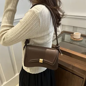 Deep brown leather rectangular shoulder bag with a curved flap and golden metal lock
