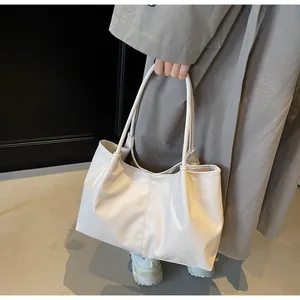 Detailed view of the large pleated tote bag with its soft white PU leather texture
