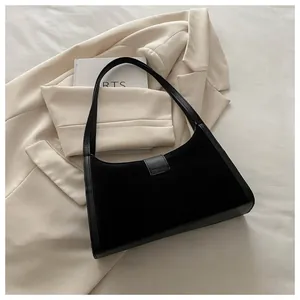 Detail of black underarm bag with mixed suede and smooth leather textures