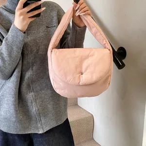 Quilted light pink shoulder bag with metallic buckle and soft padded texture design