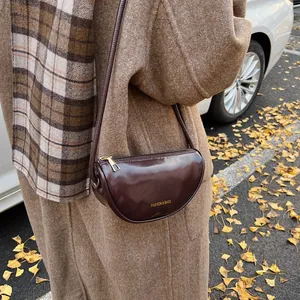 Fashionable dark burgundy half-moon crossbody bag for women with glossy mirror finish