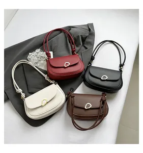 Minimalist saddle bags in four colors with gold metal buckles and woven knot straps