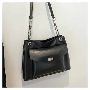 Close-up of black PU leather shoulder bag featuring silver chain strap and metal buckle