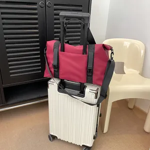Large capacity dark red travel bag with trolley sleeve on a white suitcase
