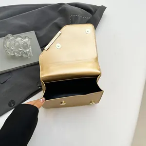 Minimalist champagne gold crossbody bag with geometric flap and magnetic closure