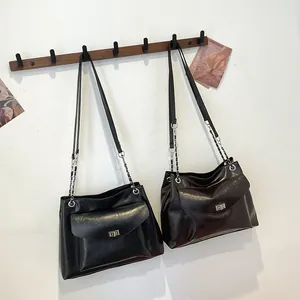 Minimalist faux leather tote bag with turn-lock closure and silver chain strap in black and brown