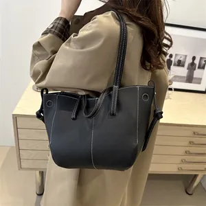 Black lychee pattern leather tote bag with white contrast stitching and shoulder strap