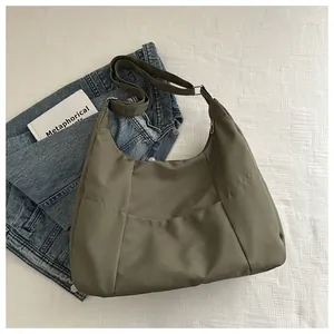 Olive green canvas hobo bag shown with adjustable shoulder strap on neutral background