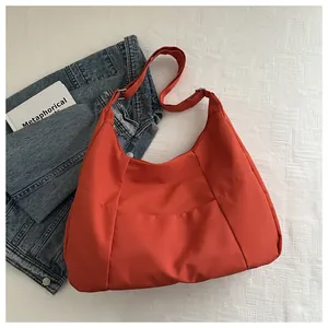 Detail view of the orange large canvas tote bag with adjustable shoulder strap