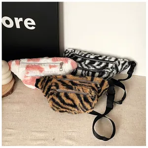Detail of plush animal print waist bags with dual zippers and adjustable straps
