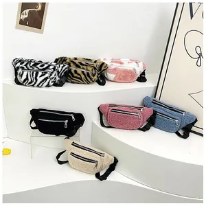 Detailed close-up of plush waist bags in animal prints and solid colors with dual zippers