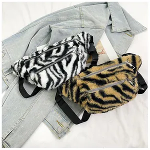 Detail of plush zebra and tiger pattern waist bags with silver zippers and adjustable straps