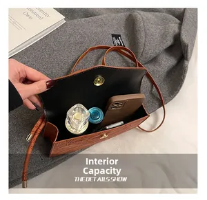 Detail view of the brown leather square bag internal capacity for phone and cosmetics
