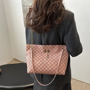 Pink chain tote bag with letter M print and gold deer charm for urban commuter style