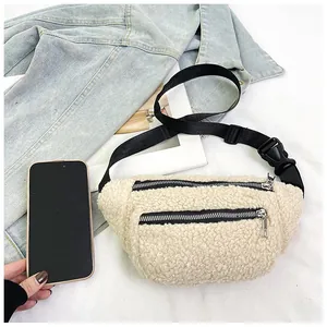 Detail of beige fleece waist bag with dual silver zippers and adjustable strap