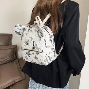 White butterfly print leather backpack with decorative ears and adjustable straps